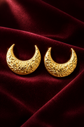 Crescent moon earrings on maroon velvet