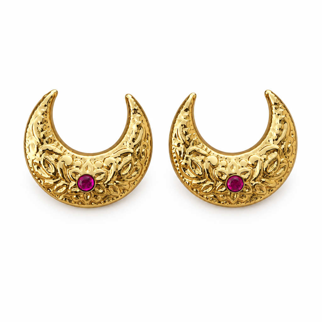 Gold crescent earrings on a white background