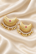 Pearl-fringe gold crescent earrings on ivory silk