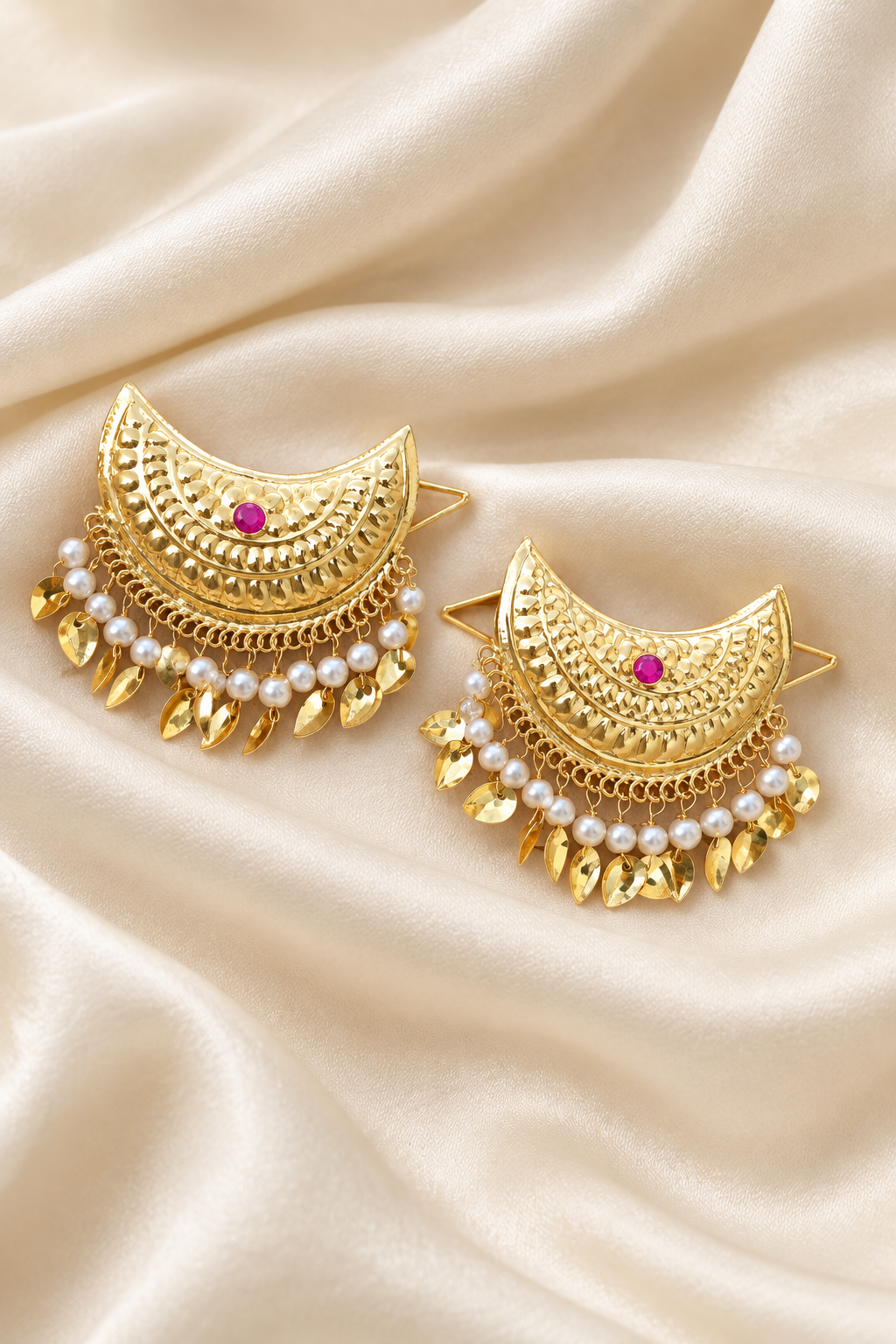 Pearl-fringe gold crescent earrings on ivory silk